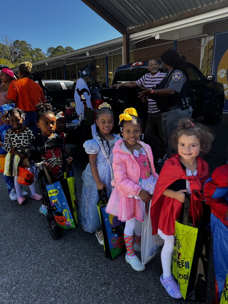 Smiling children in costumes.
