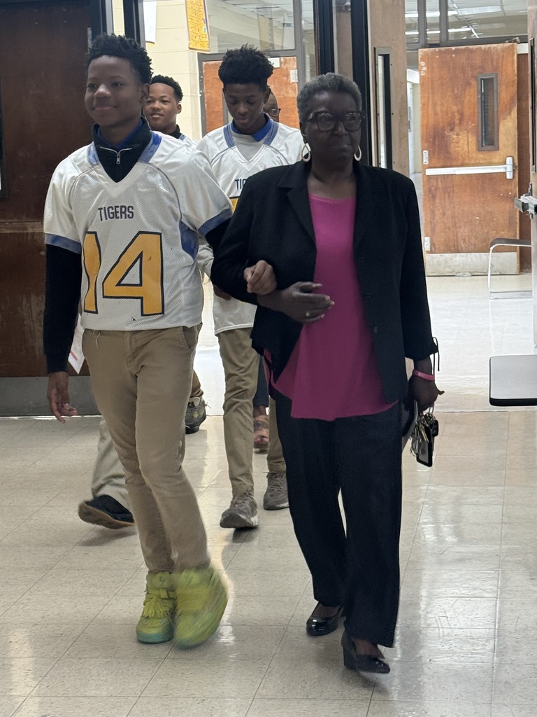 A student escorts a woman.