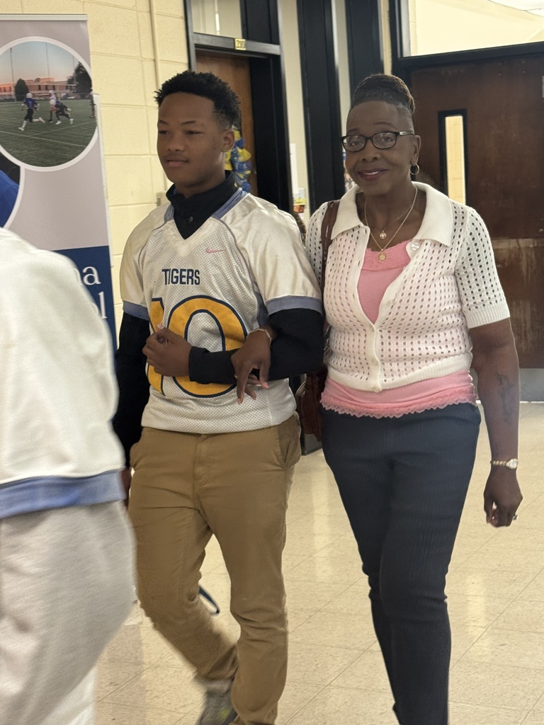 A student escorts a woman.