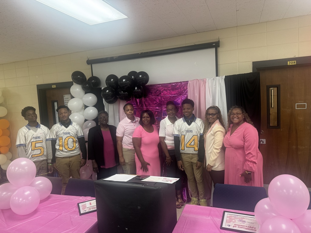 A group of people gather for breast cancer awareness.