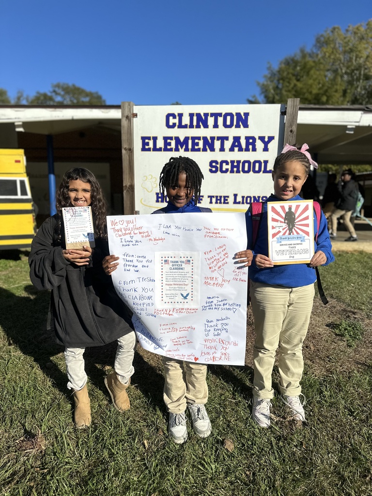 Students holding up thank you cards.