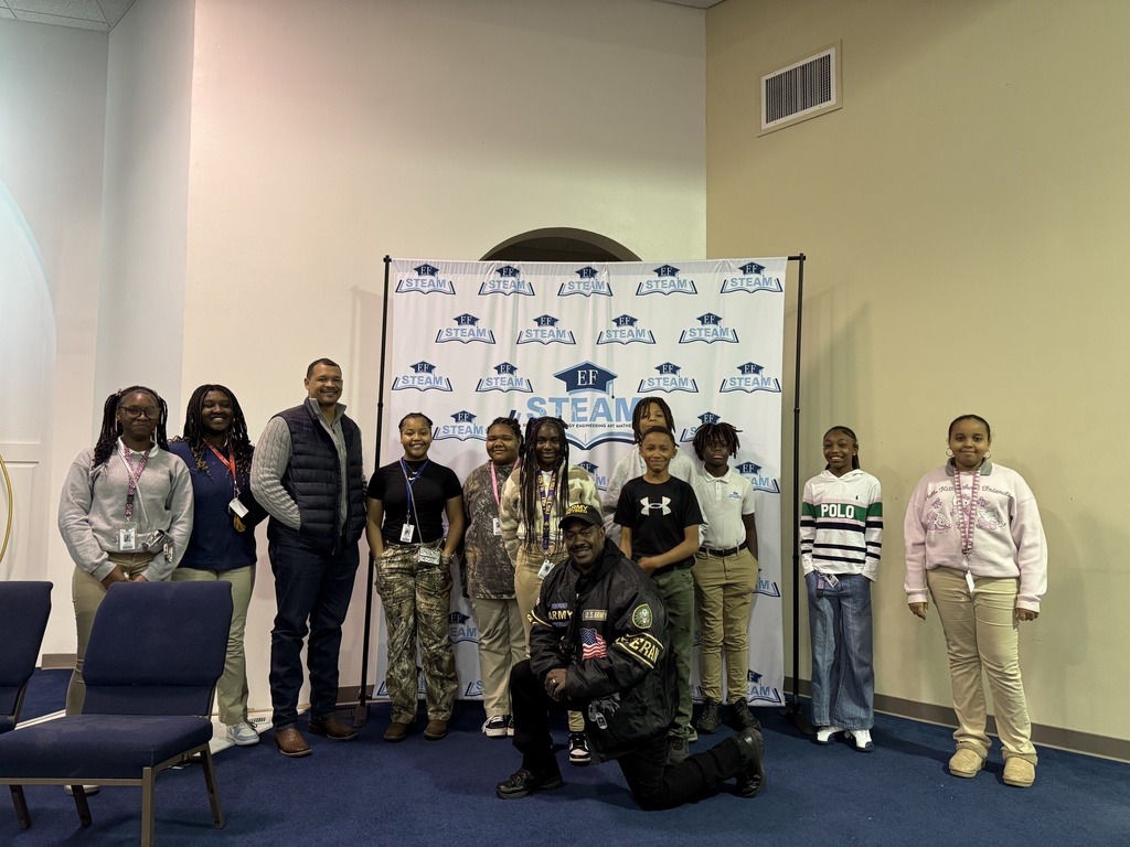A group of students standing with veterans.