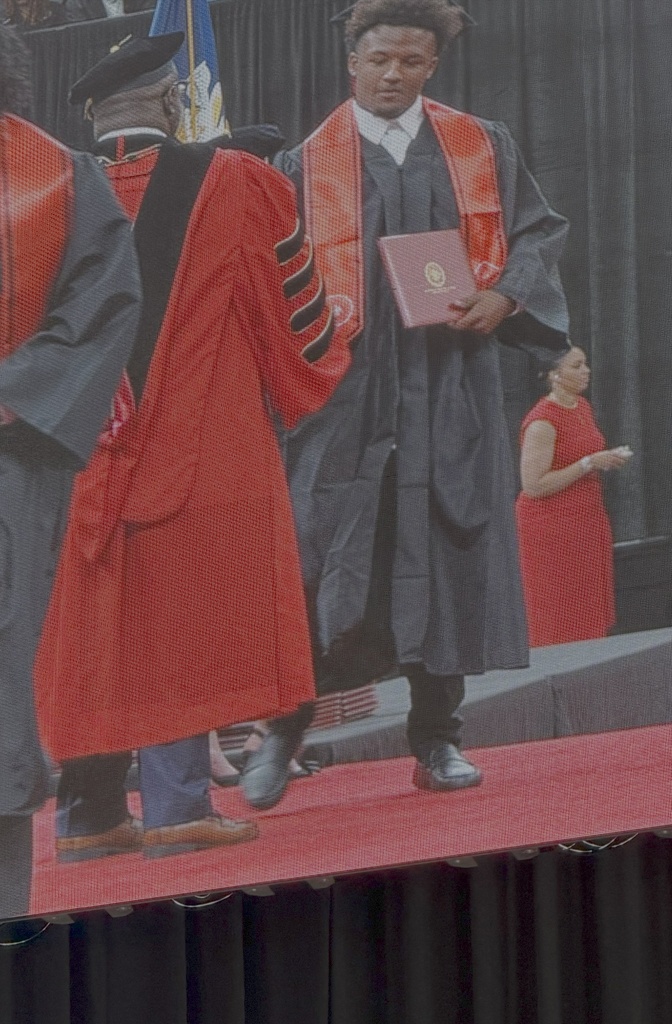 Student receiving diploma.