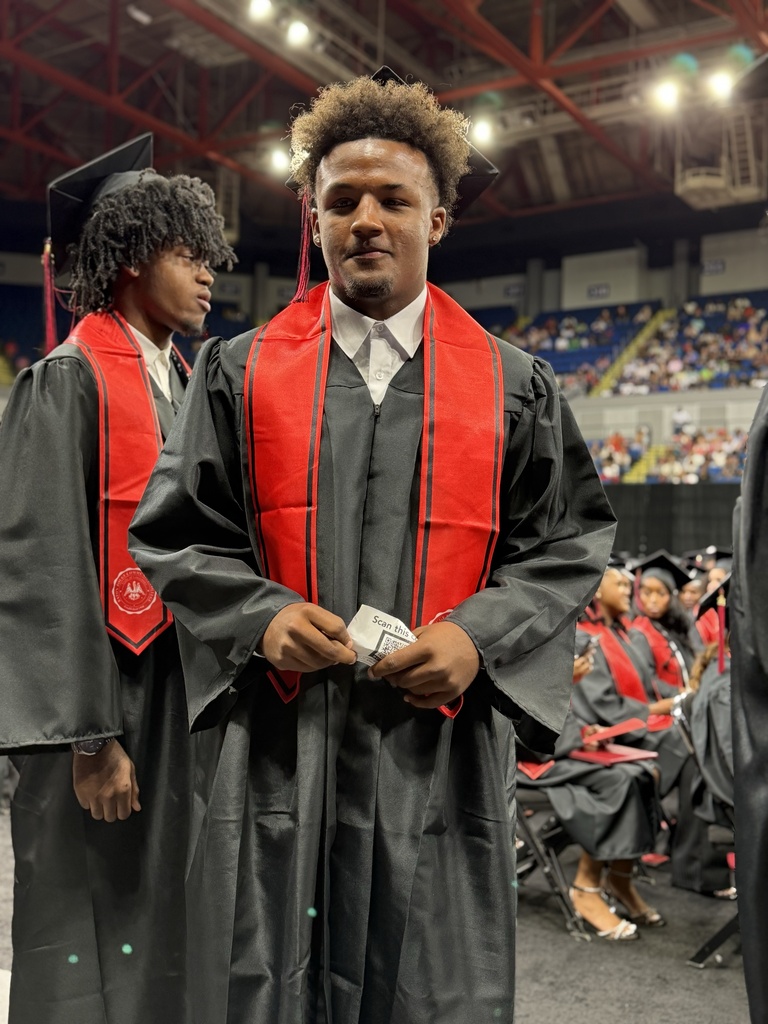 A student in a graduation robe.