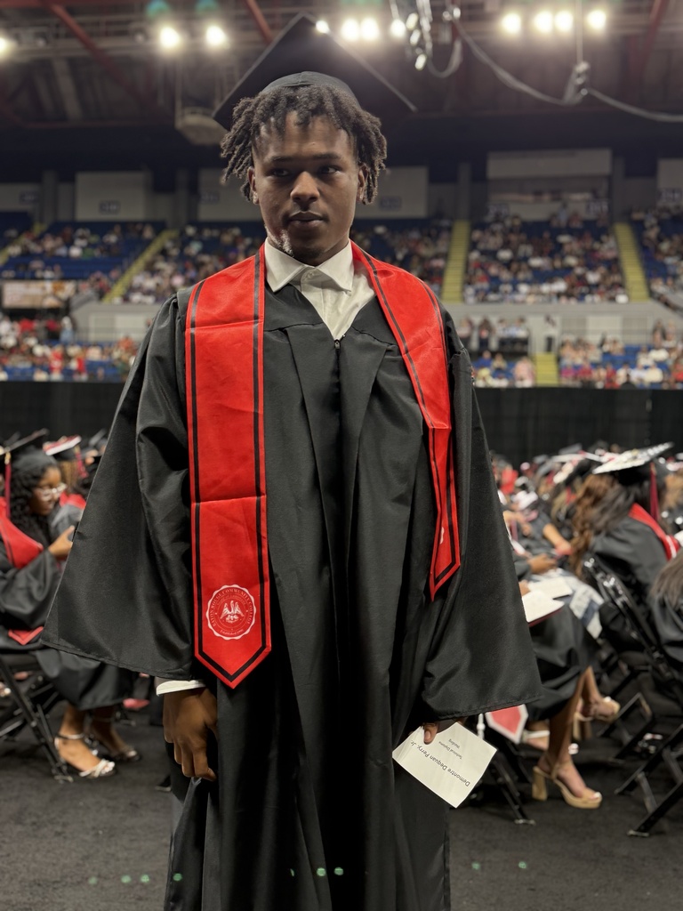 A student in a graduation robe.