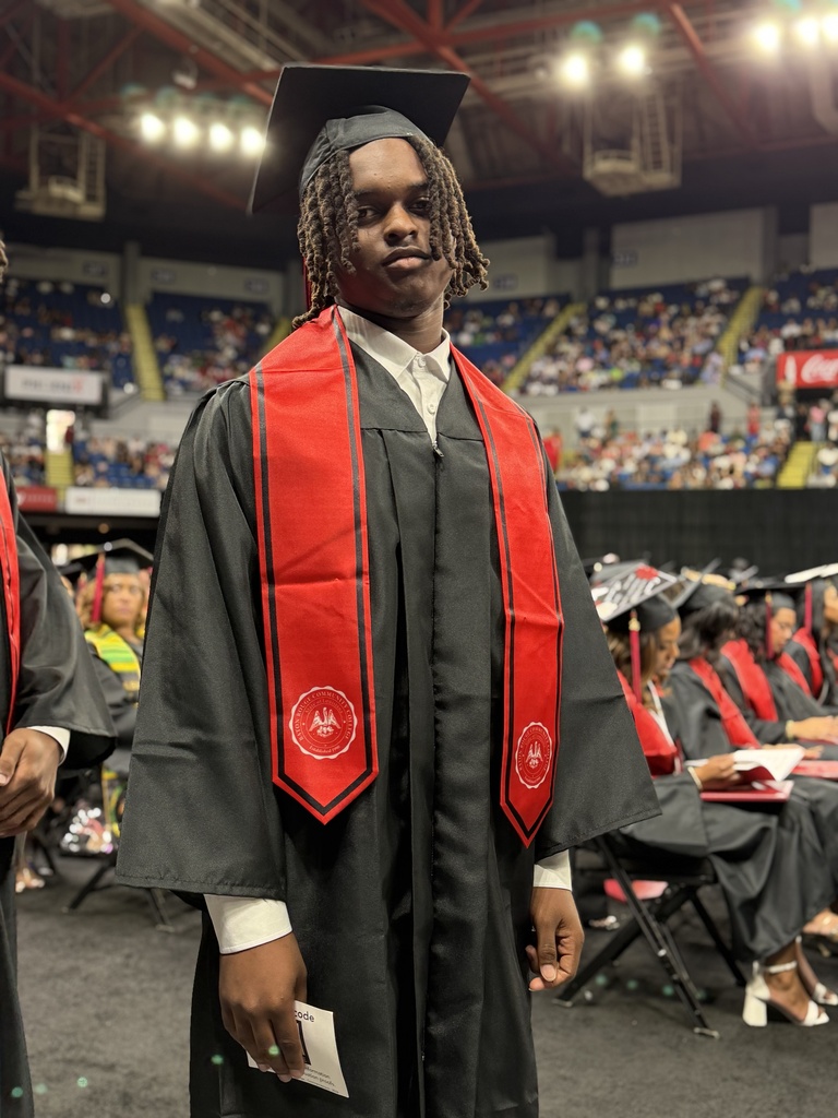 One student in a graduation robe.