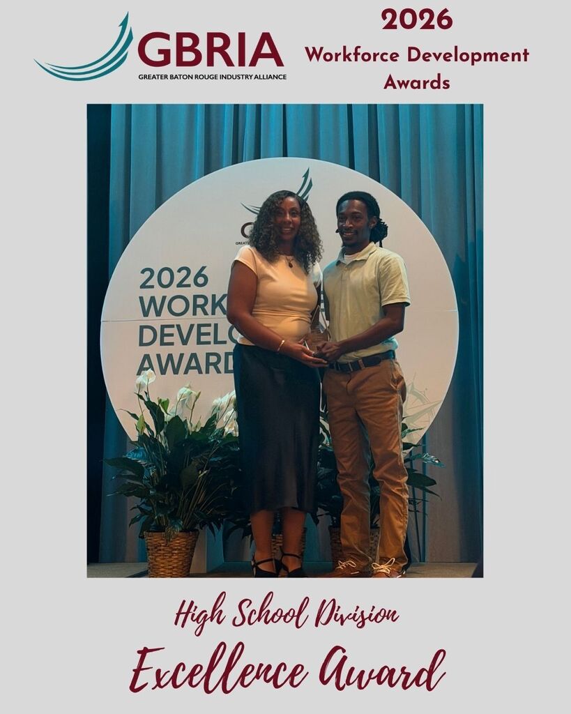 A photo of two people holding a GBRIA Excellence Award