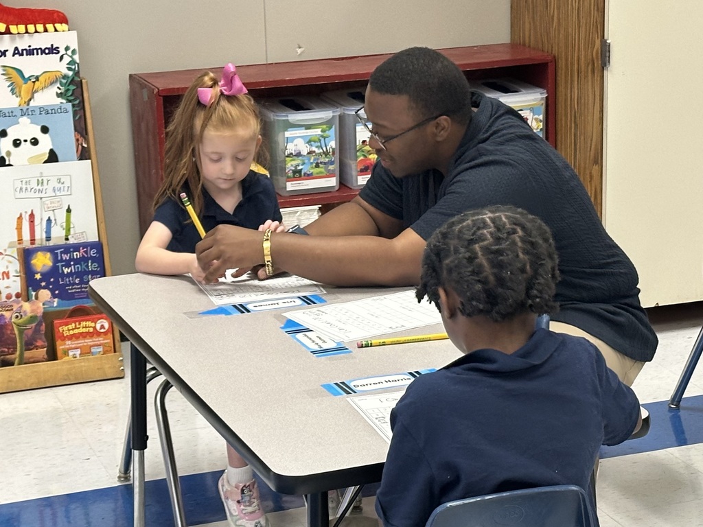 A teacher works with a student.