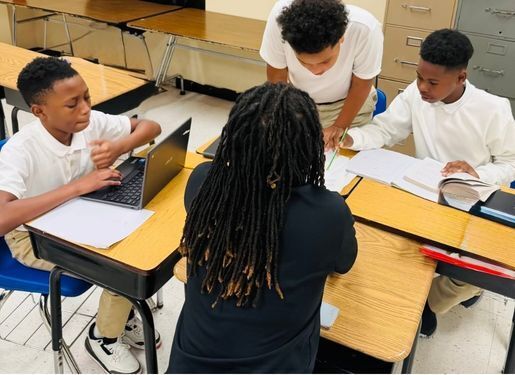 Students doing math with a teacher.