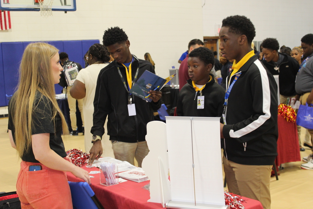 Students talk to a college ambassador.