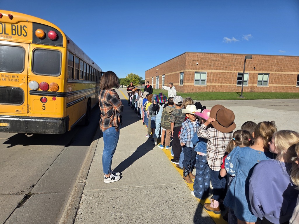 Students are waiting to board the bus for Bus Safety