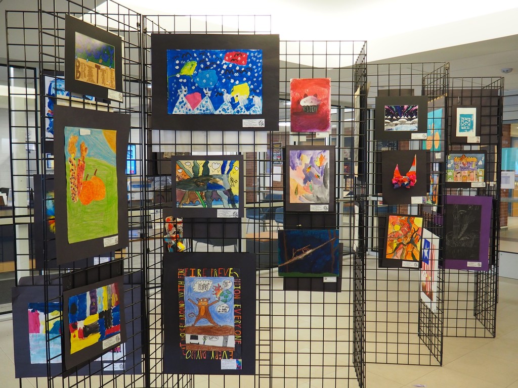 Entrance to Art Show racks with many art works