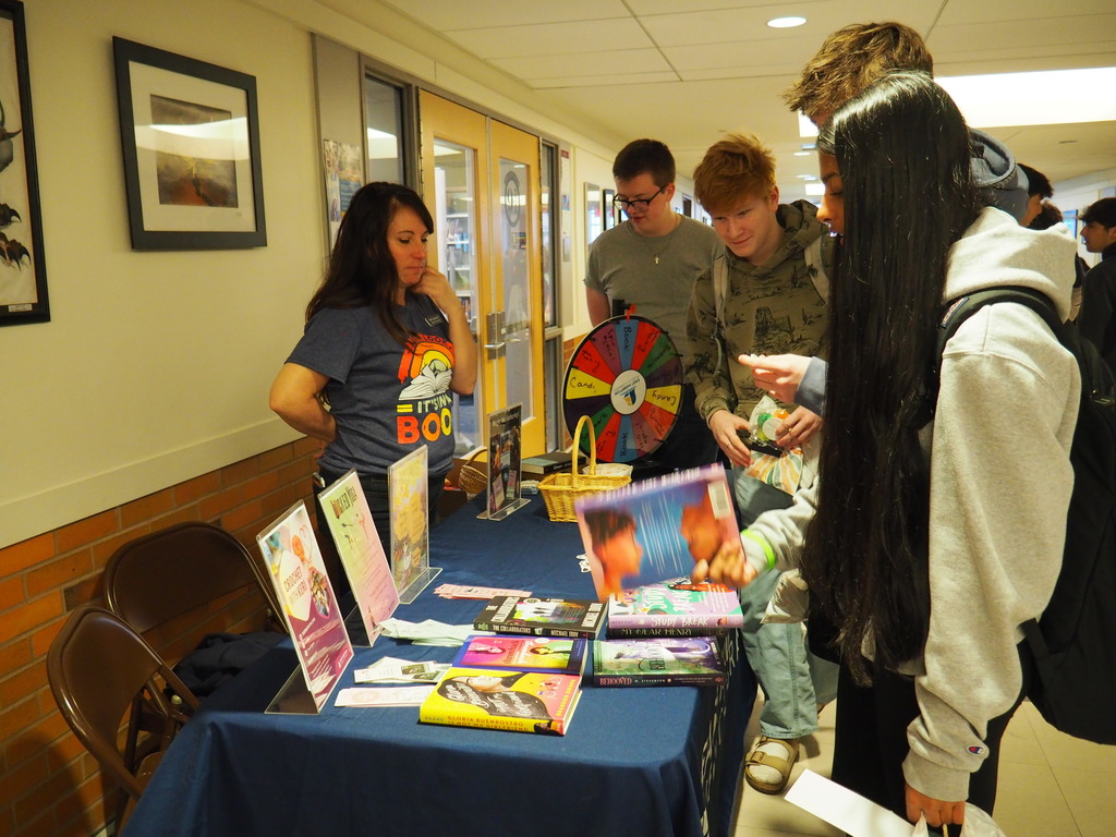 Public Library rep with students at Wellness Fair Community groups tables