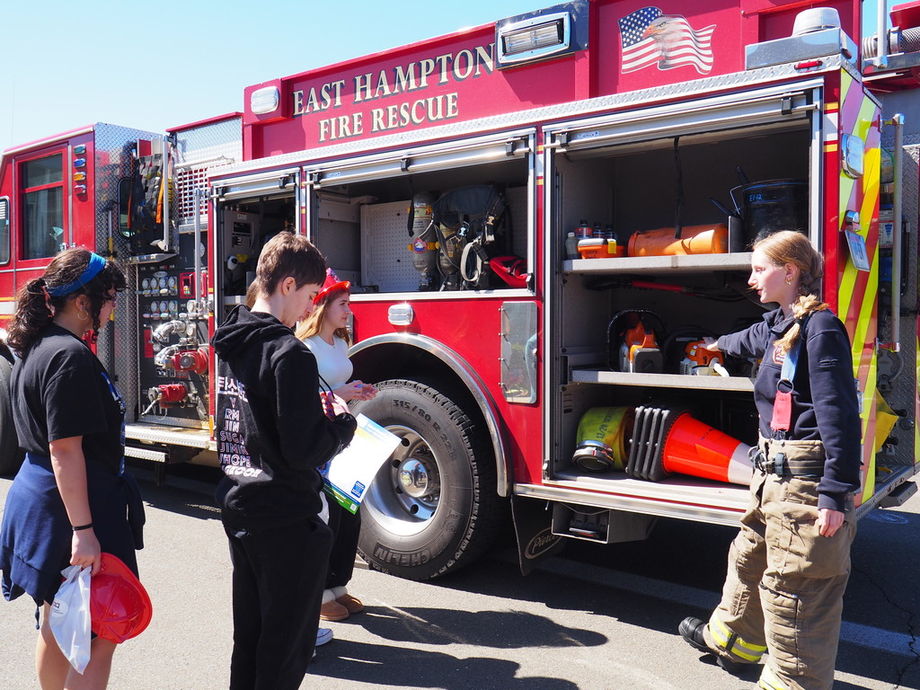 Female Junior Firefighter giving equipment tour