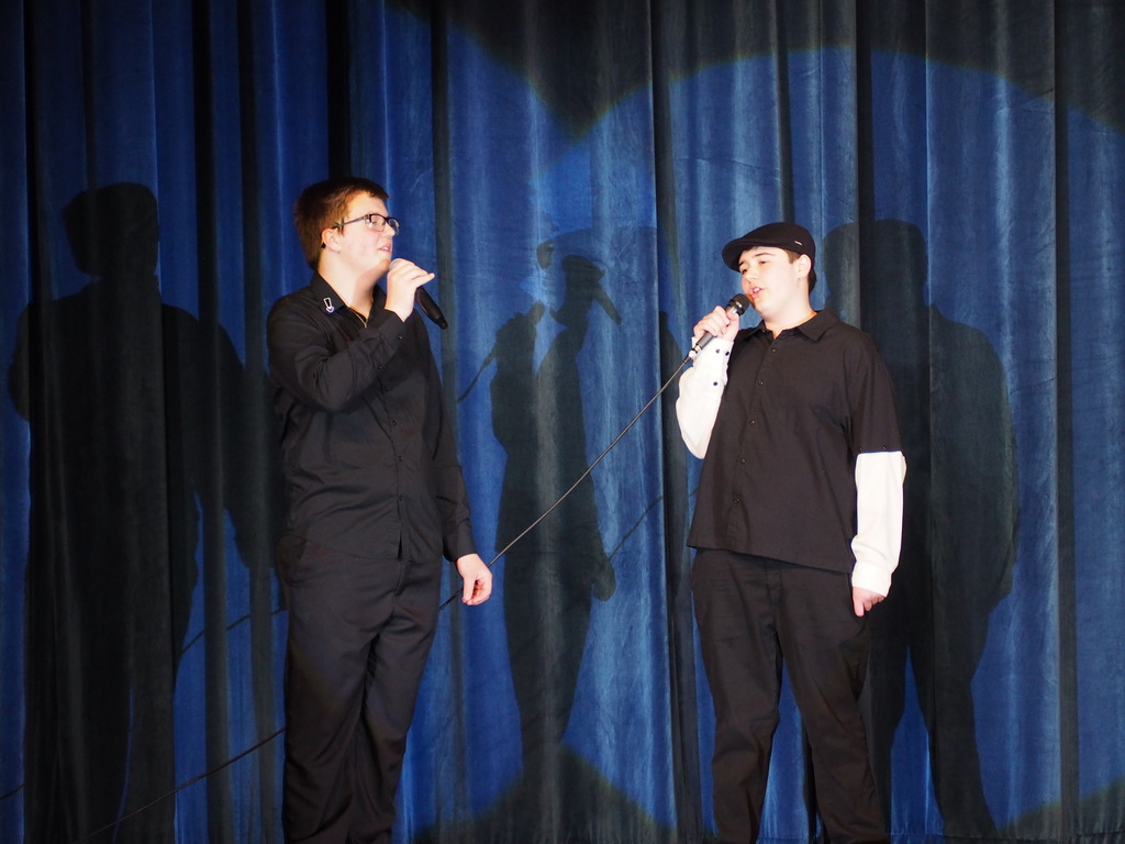 2 male students duet dressed in black
