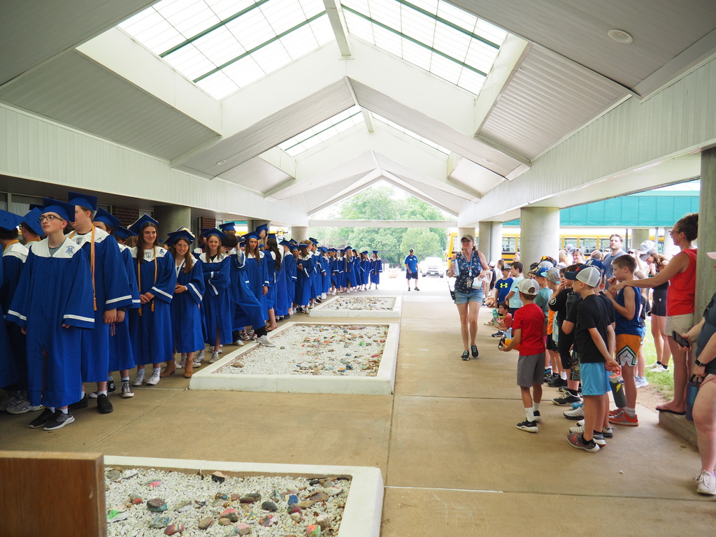 Seniors being cheered by elementary students outside