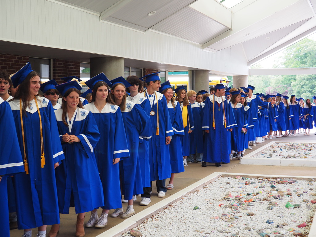 Seniors in Cap and Gowns lined up outside of Memorial School