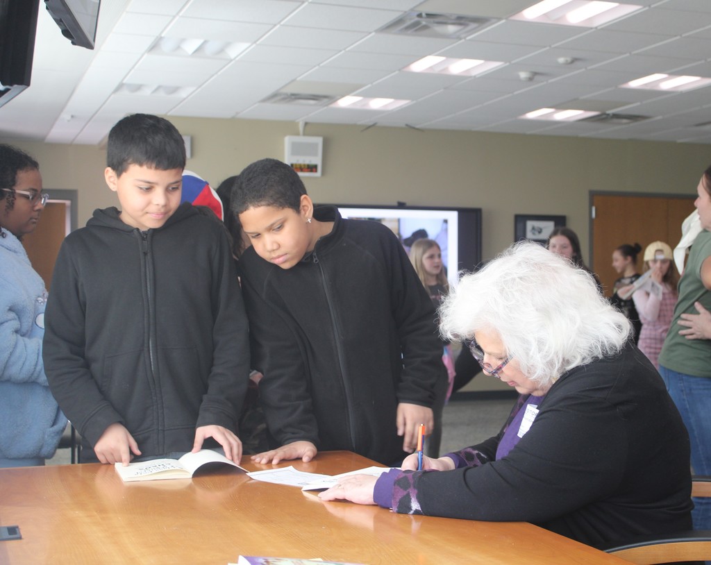 students getting book signed