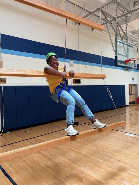 Student smiles while on the obstacle course
