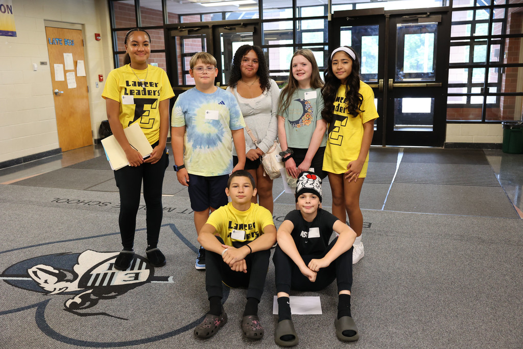 Students pose in front of EIMS while touring the school
