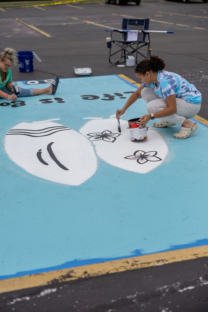 students painting their parking spot