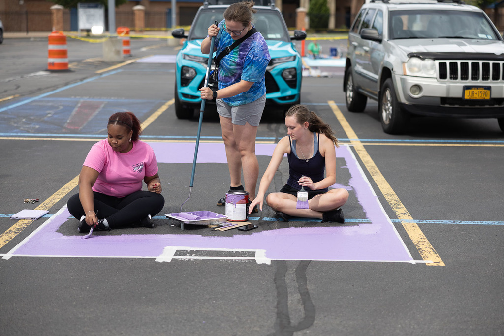 students painting their parking spot