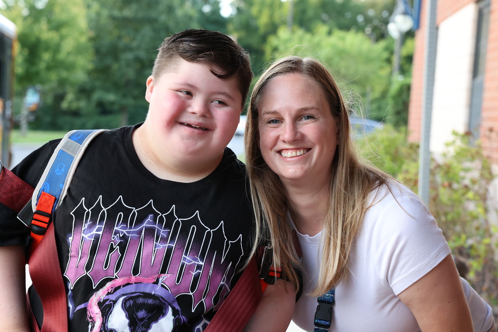Student and teacher pose for a photo