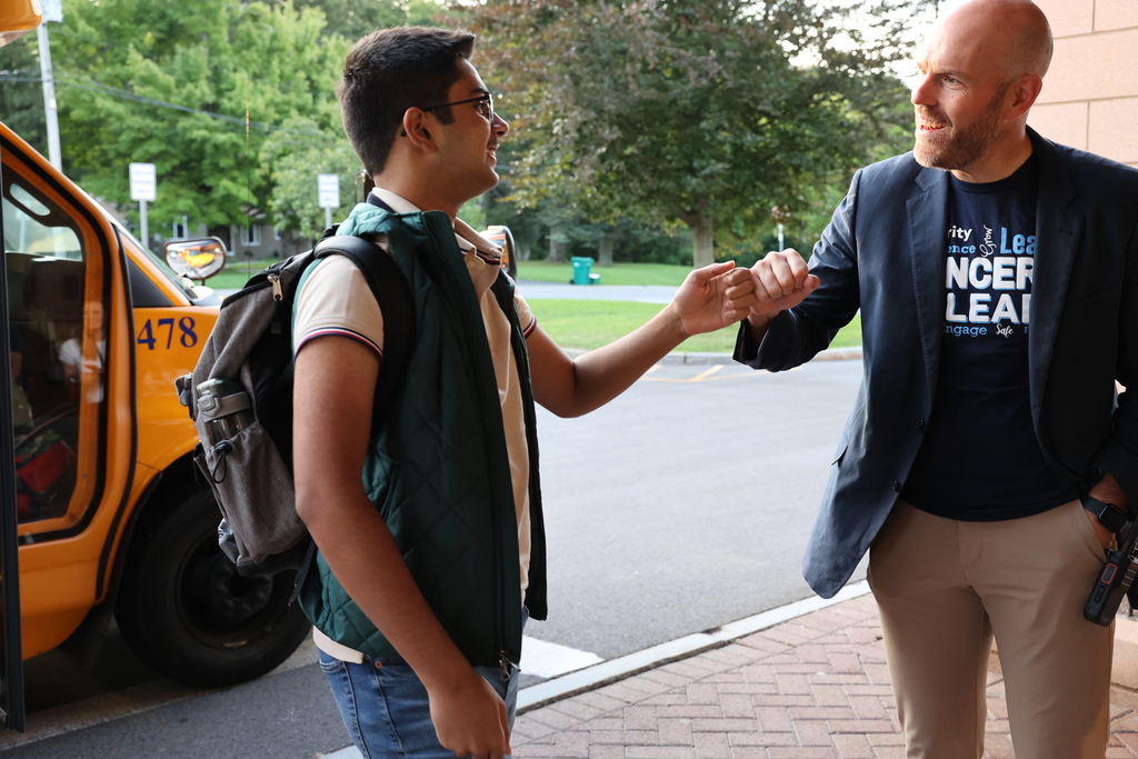 student fist bumps the principal 