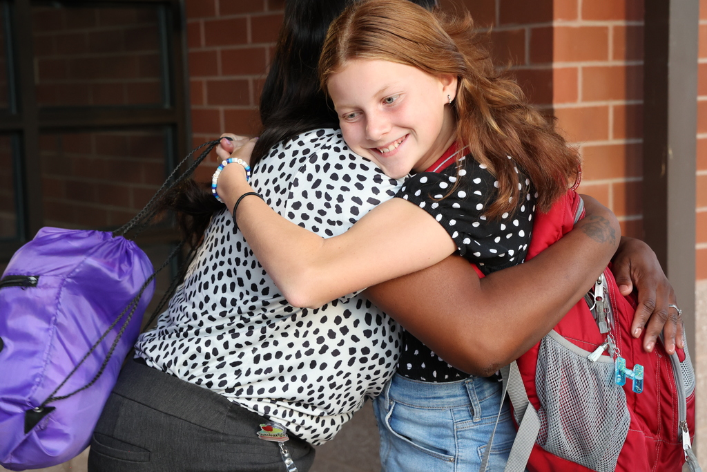 Student hugs teacher
