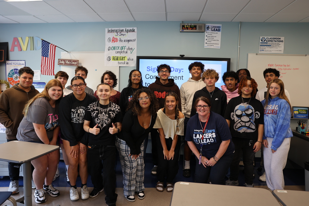 Students pose for a group photo in the classroom