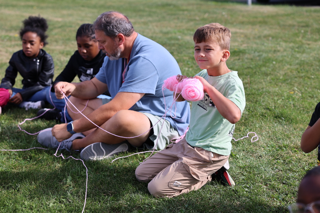 Student smiles with yarn in hands