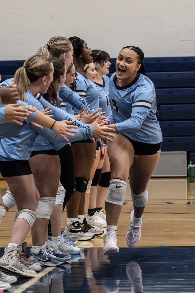 volleyball team gives high fives