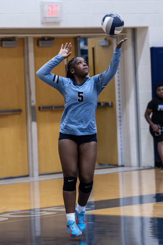 Volleyball player serves the ball