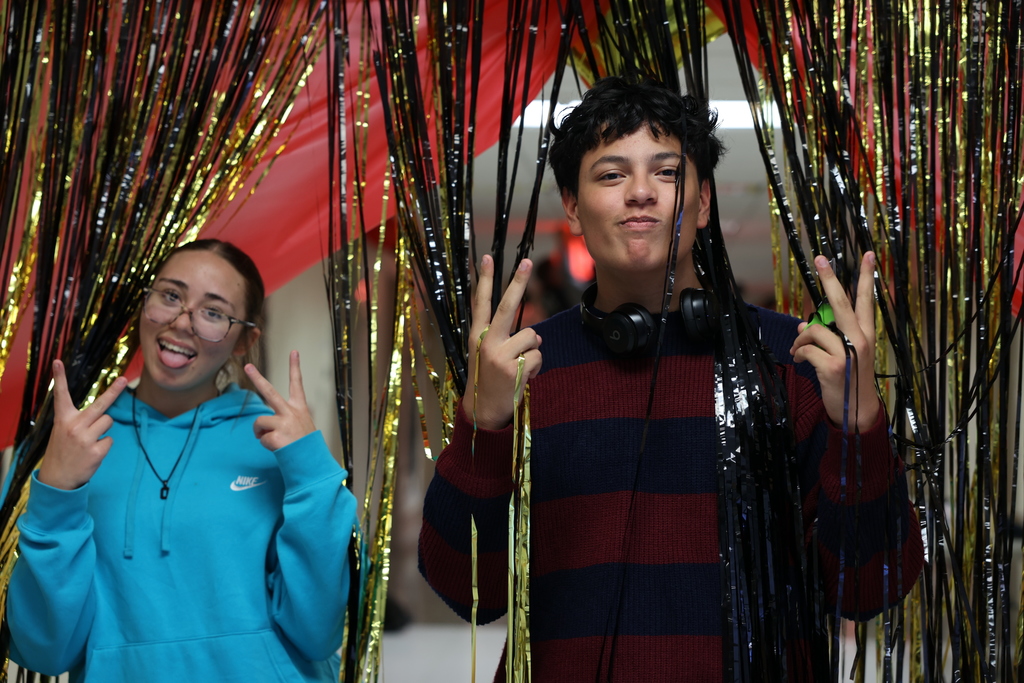 Students post in doorway glitter