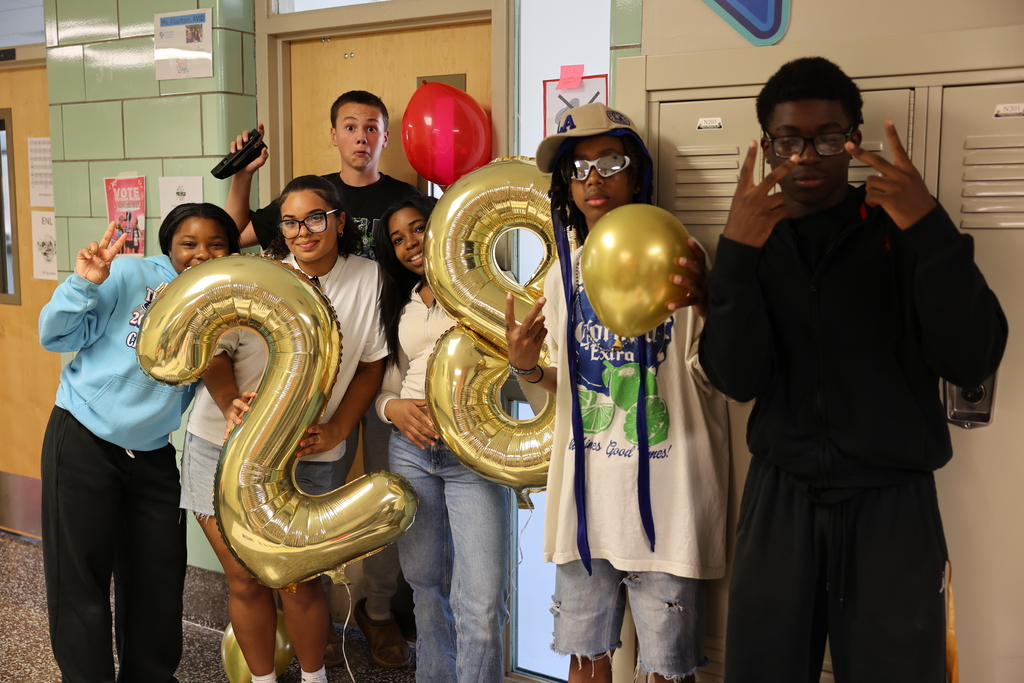 Students pose with 28 number balloon