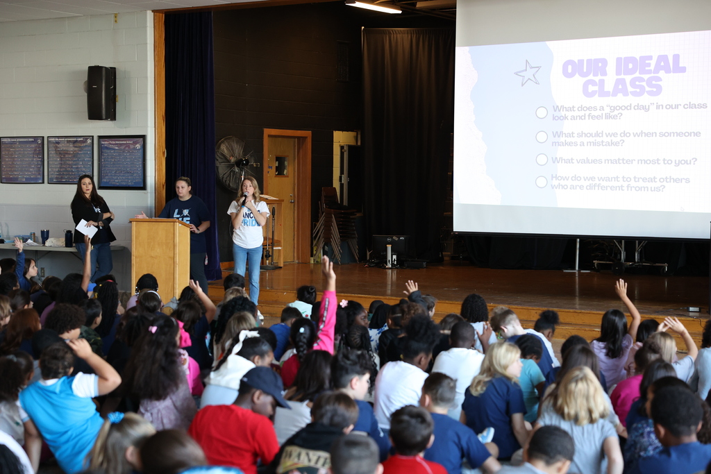 Students listen to a presentation during an assembly