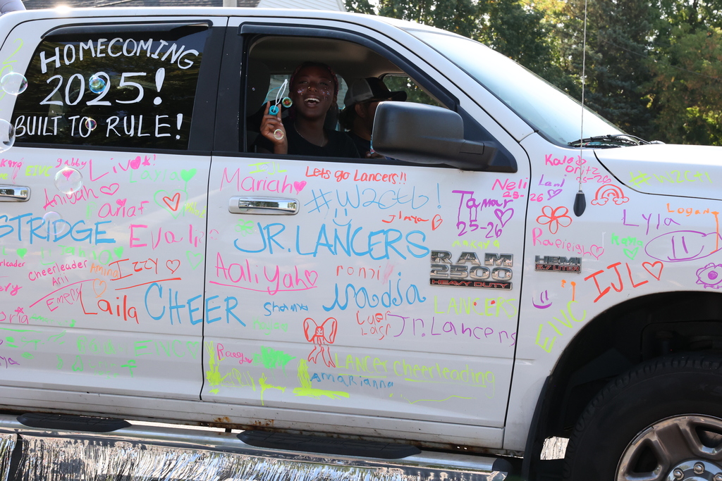 Homecoming 2025! Built to Rule written on truck with someone blowing bubbles out the window