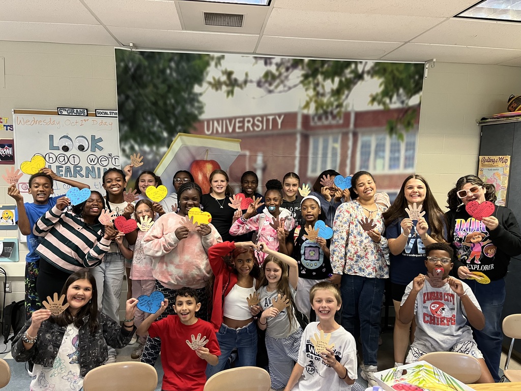 Students hold up their hands and hearts for I have a dream club