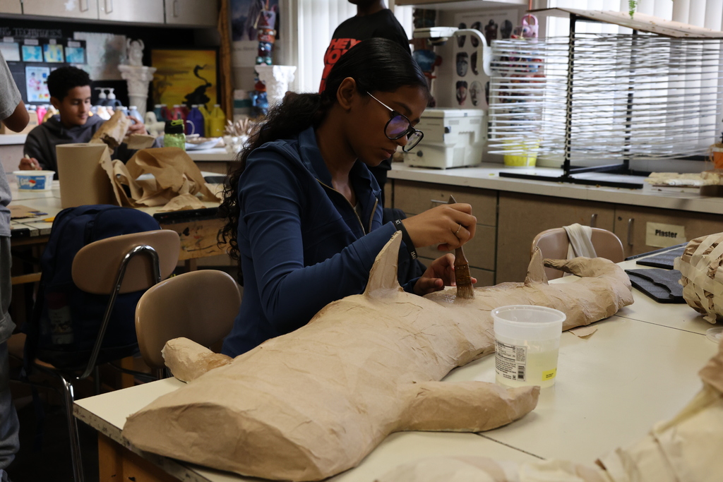 student paints hammerhead shark