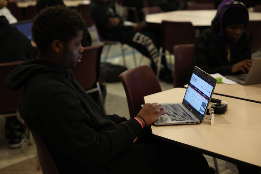 Student looks at laptop