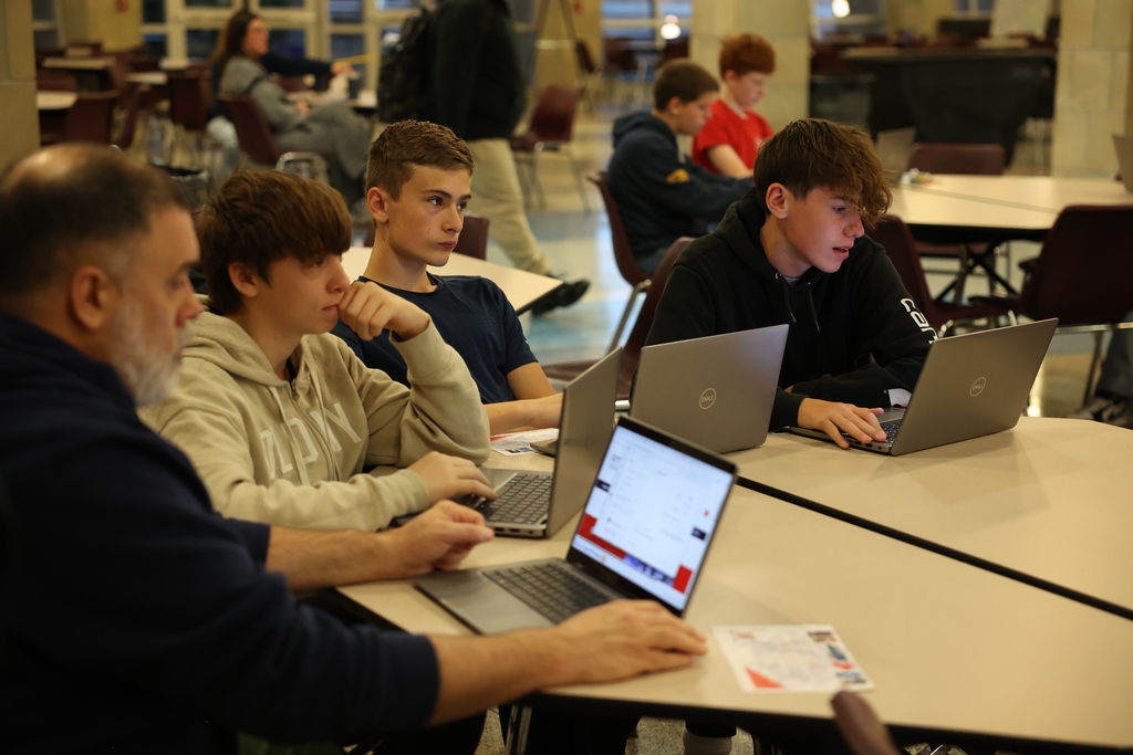 Students look at laptops