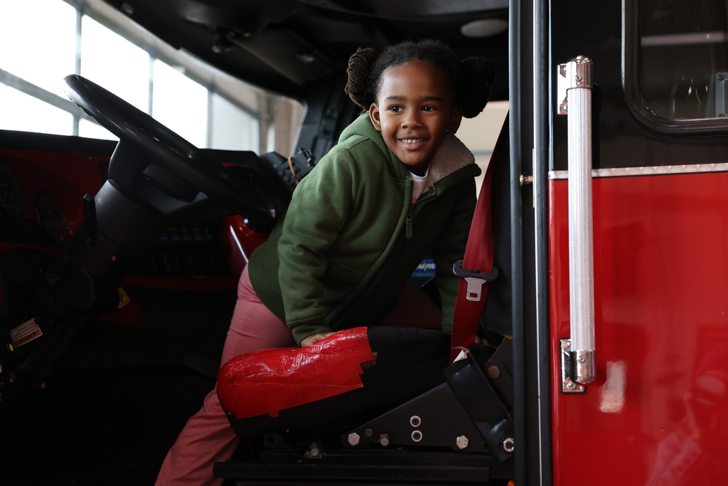 Student smiles in firetruck