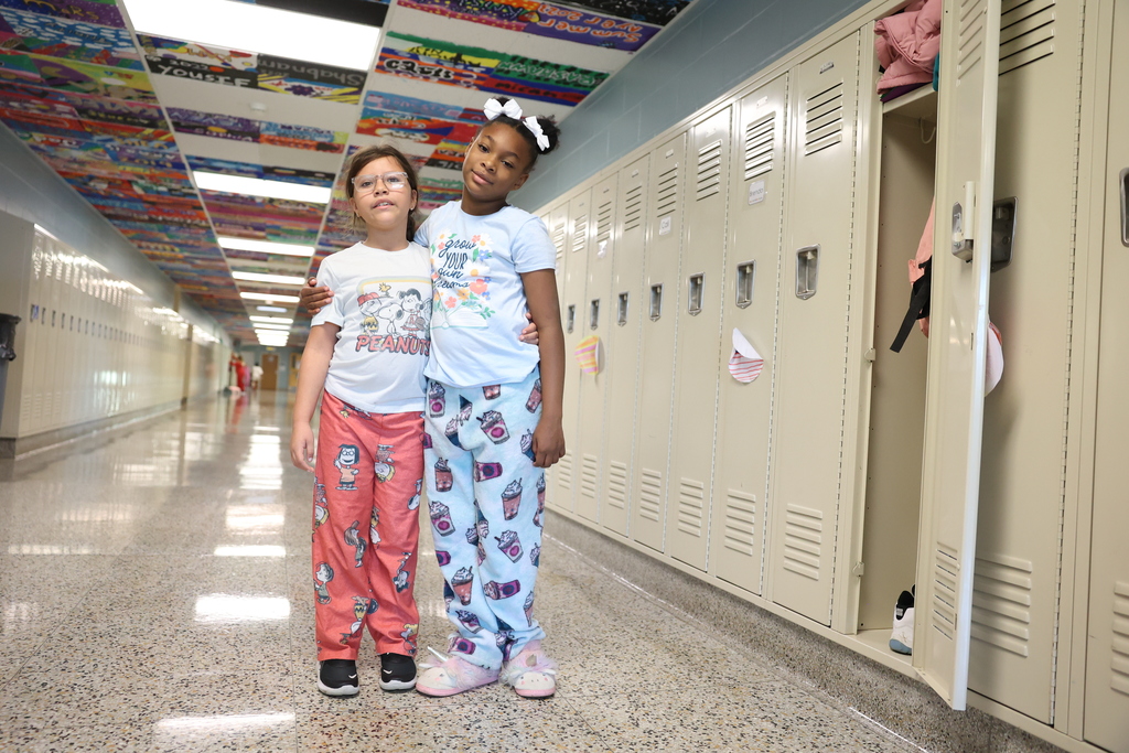 students pose for a photo in the hallway with their pjs