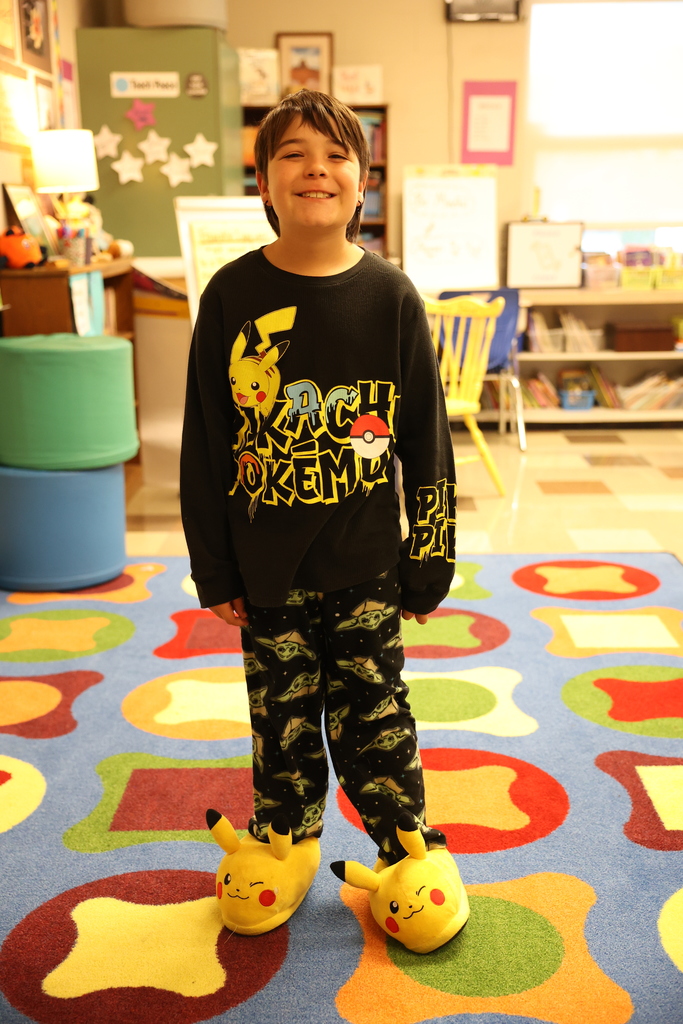 student poses with pokemon pjs