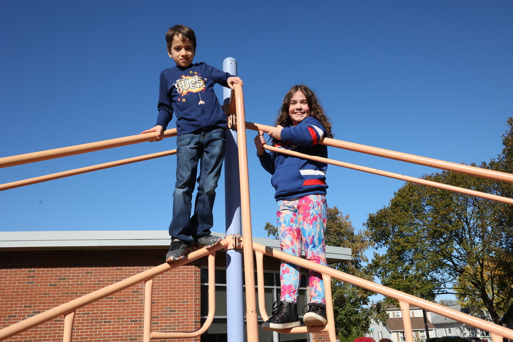 Students pose on the playground equipment