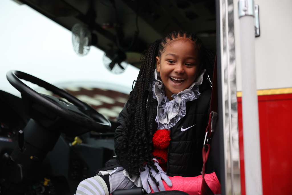student smiles on the fire truck