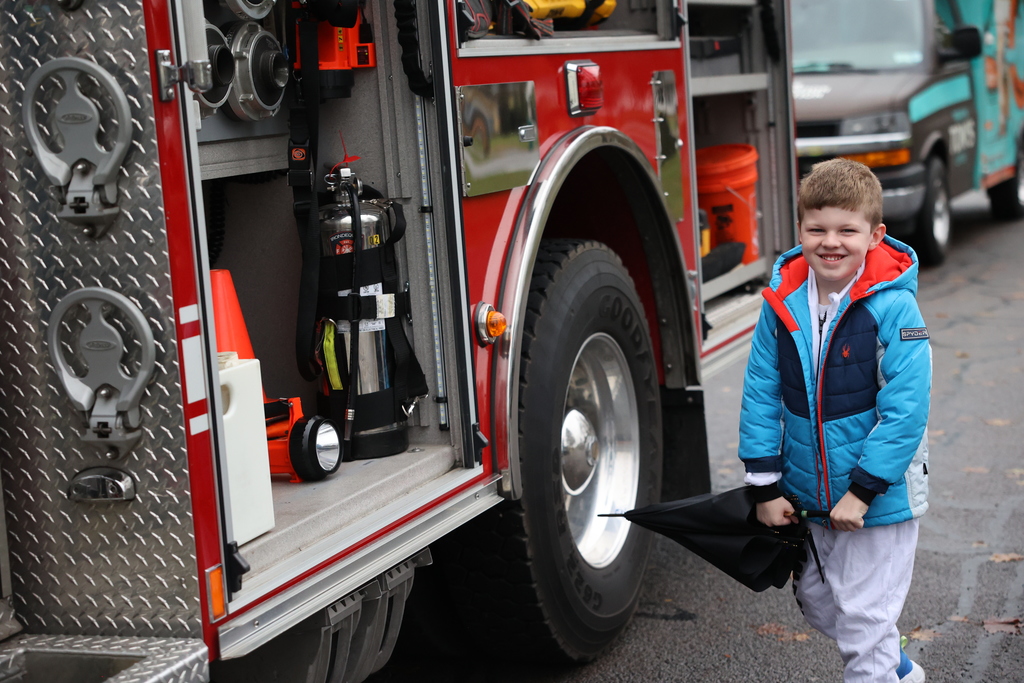 Student stands next to fire truck