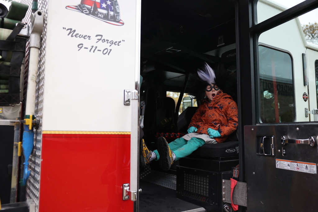 student wears costume on the fire truck 
