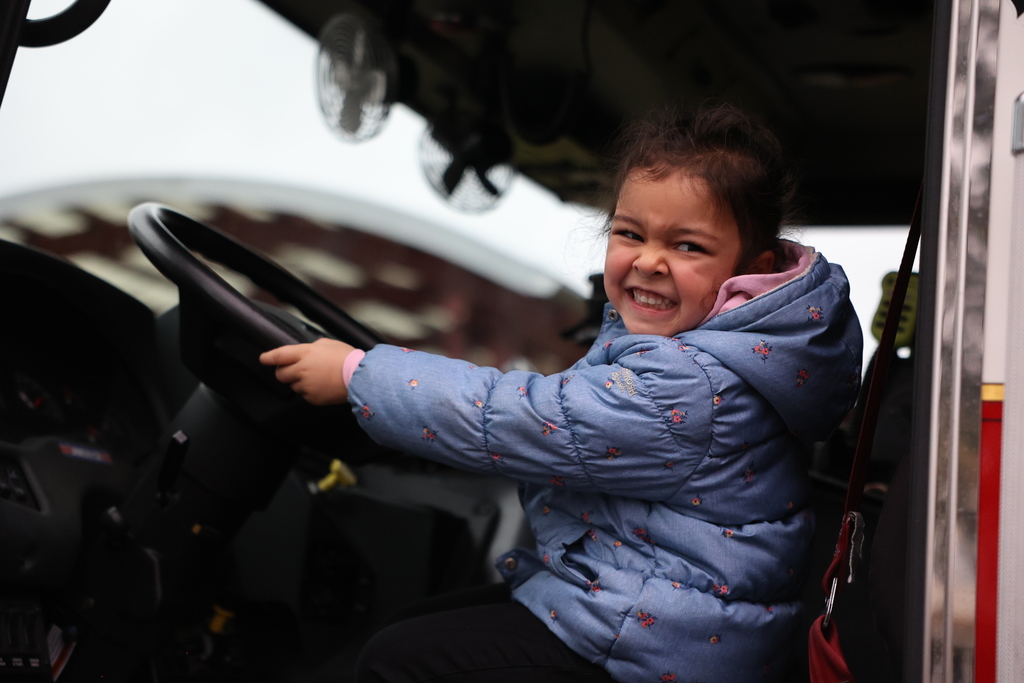 Student smiles on the fire truck