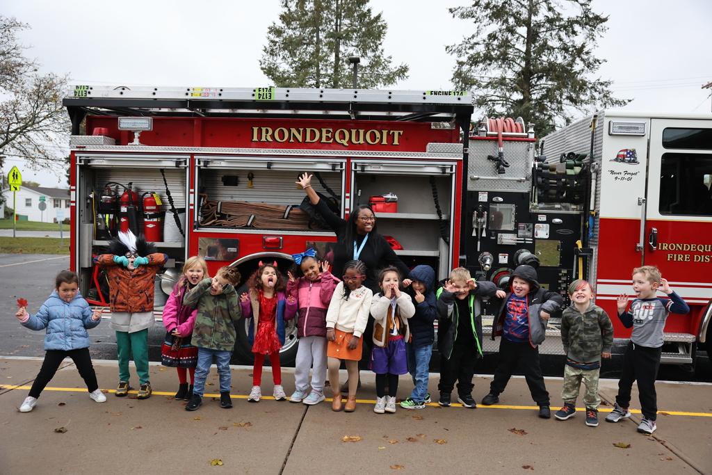 Students pose in front of the fire truck with teacer